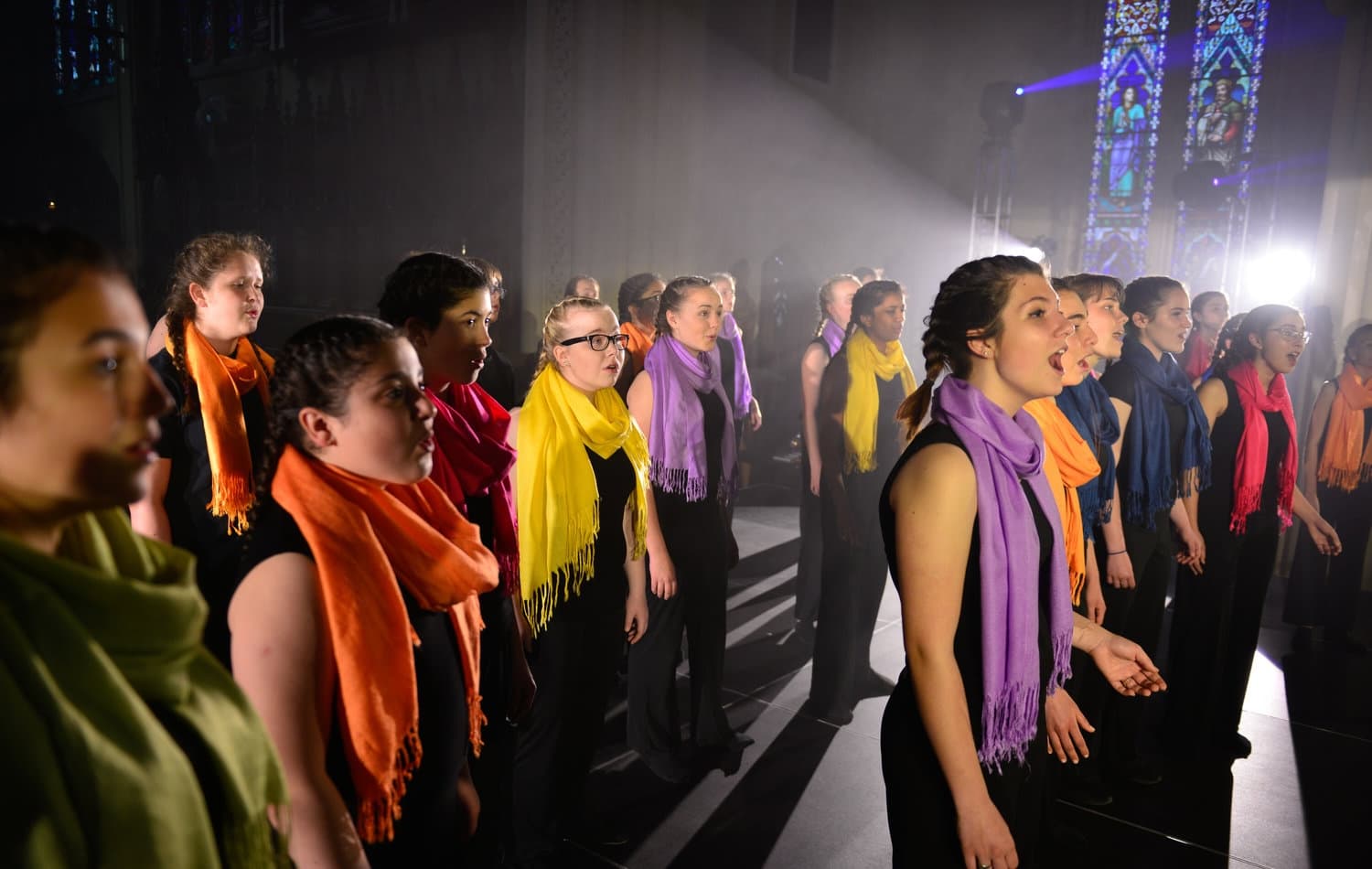 Hamilton Children's Choir performing in a cathedral with dramatic lighting